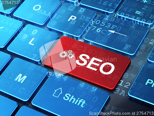 Image of Web development concept: Gears and SEO on computer keyboard back