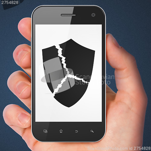 Image of Security concept: Broken Shield on smartphone