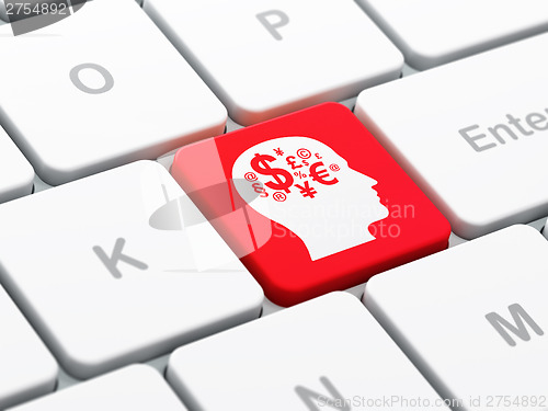 Image of Advertising concept: Head With Finance Symbol on computer keyboa