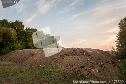 Image of Large pile of soil under blue sky