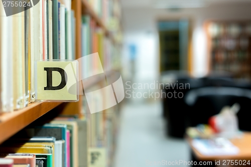 Image of Library bookshelf closeup with letter