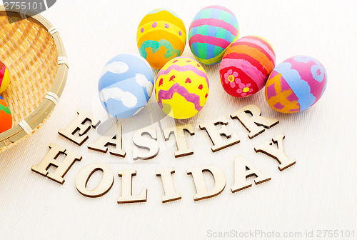 Image of Painted easter egg in basket with wooden text