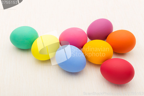 Image of Colourful easter egg over white linen background