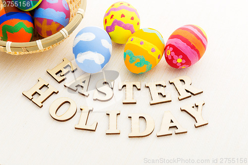 Image of Colourful easter egg with wooden text 