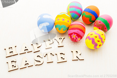 Image of Colourful easter egg and wooden letter