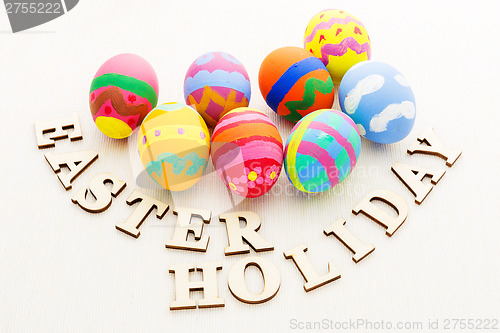 Image of Colourful easter egg with wooden text