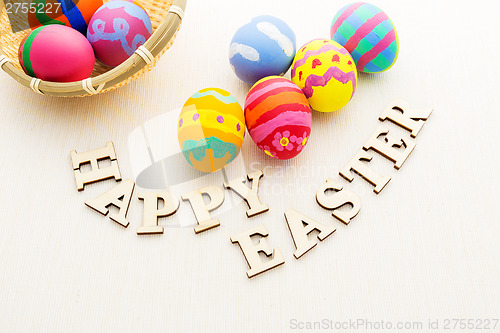 Image of Painted easter egg in basket with wooden text