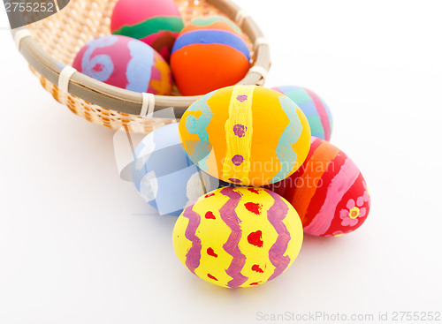 Image of Colourful painted easter egg in basket