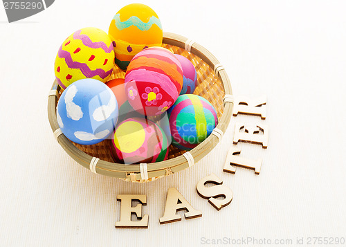 Image of Easter egg in basket and wooden text