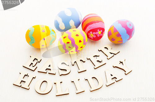 Image of Colourful patterm easter egg with wooden letter