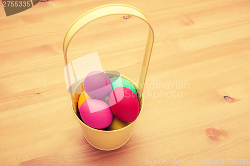 Image of Colourful painted easter egg in busket