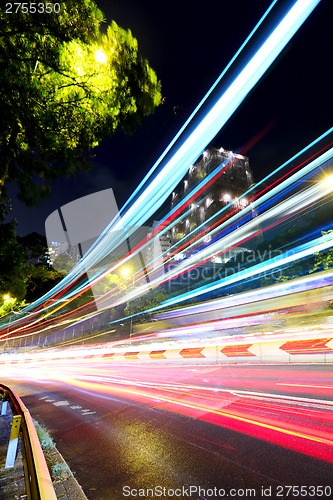 Image of Fast moving car light on street