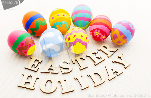 Image of Colourful easter egg with wooden text
