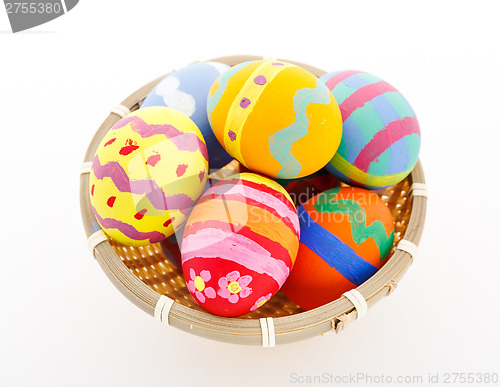 Image of Colourful painted easter egg in basket