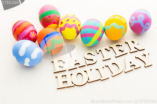 Image of Colourful pattern easter egg with wooden text