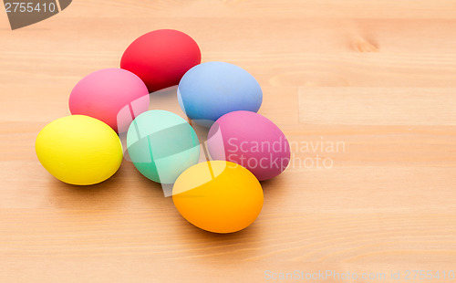 Image of Colourful easter egg over wooden background