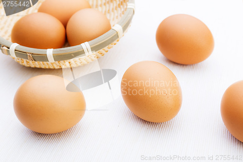 Image of Fresh brown and white eggs on white cloth
