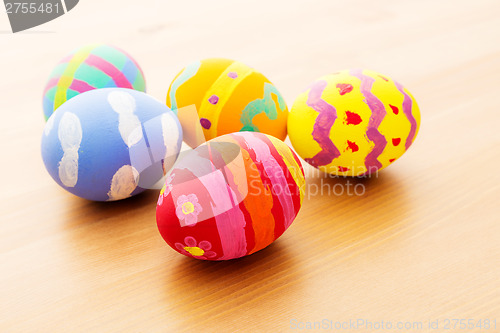 Image of Colourful easter egg on wooden background