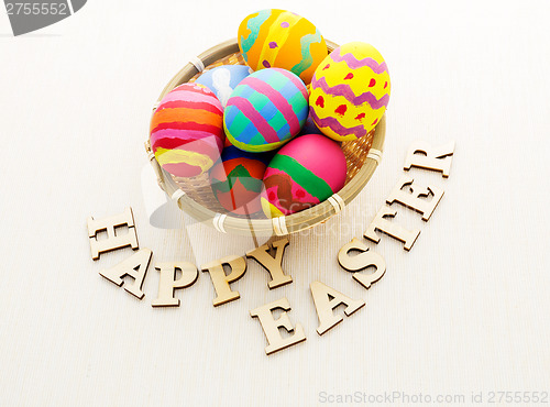 Image of Colourful easter egg with wooden text