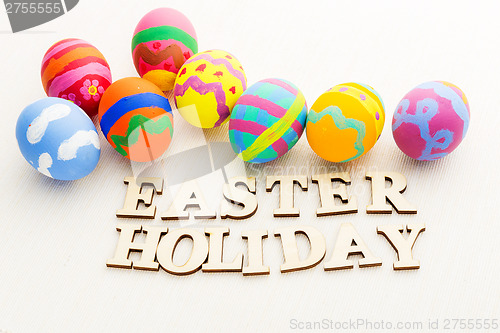 Image of Colourful easter egg with wooden text 