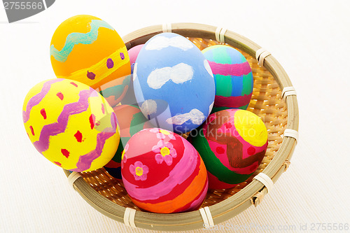 Image of Colourful easter egg in wicker basket