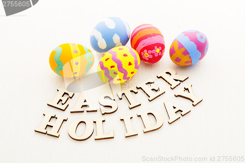 Image of Colourful easter egg with wooden text