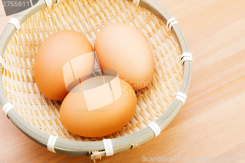 Image of Brown chicken egg in basket