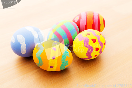 Image of Colourful easter egg on wooden table