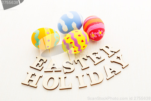 Image of Colourful Painted easter egg with wooden text 