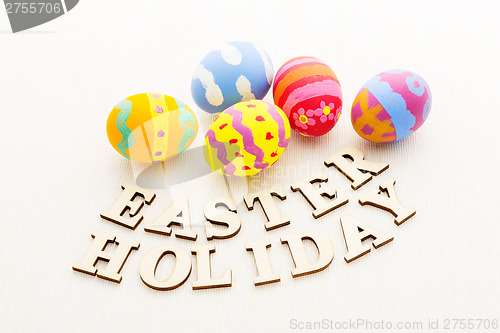 Image of Colourful easter egg with wooden text