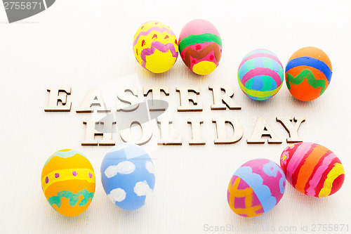 Image of Colourful easter egg with wooden letter