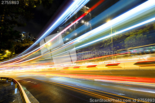 Image of Fast moving car light on road at night