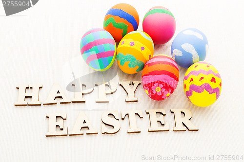 Image of Children painted easter egg with wooden text