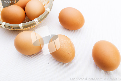 Image of Fresh brown and white eggs on white cloth