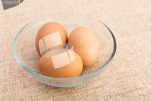 Image of Egg in bowl over linen background