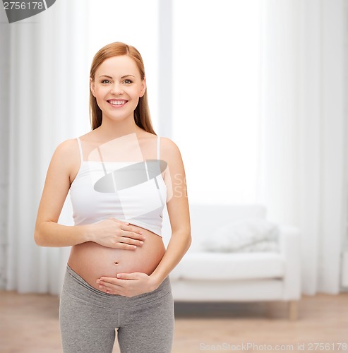 Image of happy future mother touching her belly