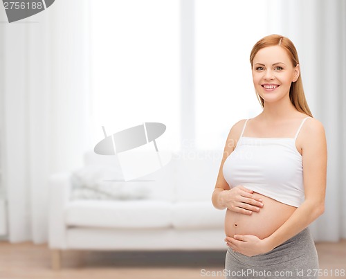 Image of happy future mother touching her belly