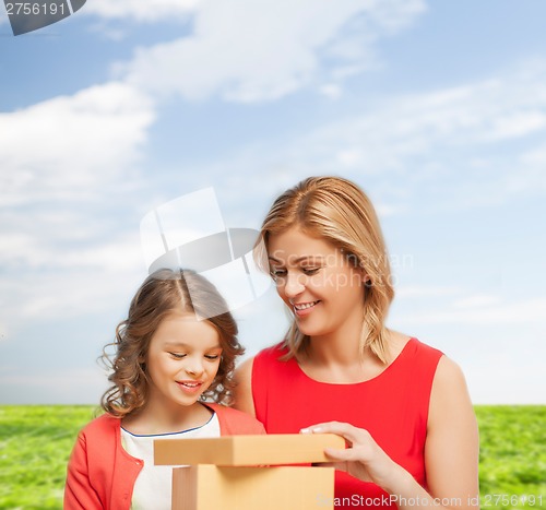 Image of smiling mother and daughter with gift box