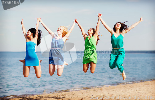 Image of girls jumping on the beach