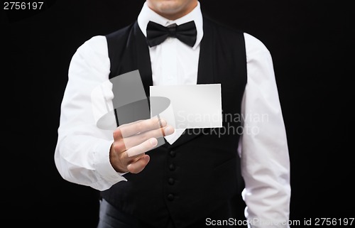 Image of dealer holding white card