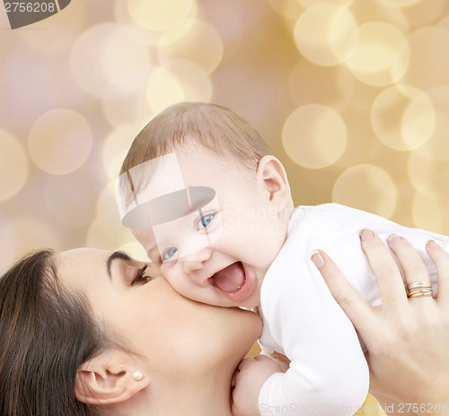 Image of laughing baby playing with mother