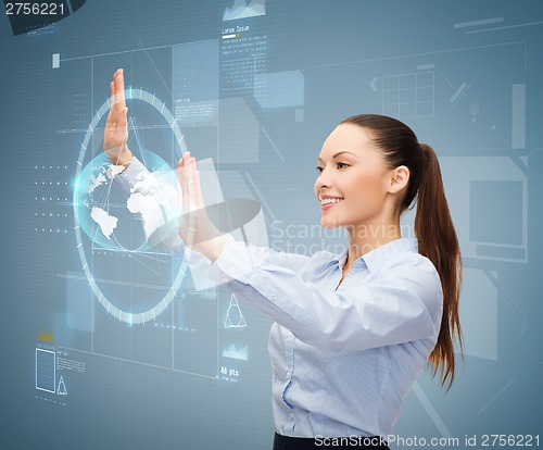 Image of smiling businesswoman working with virtual screen