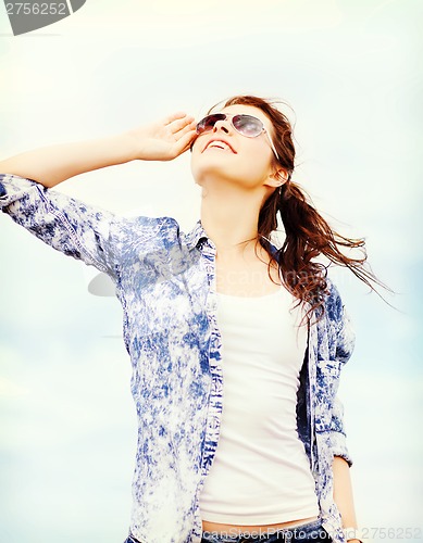 Image of teenage girl in shades outside