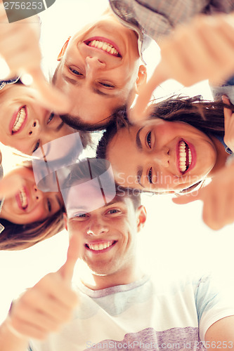 Image of group of smiling teenagers looking down