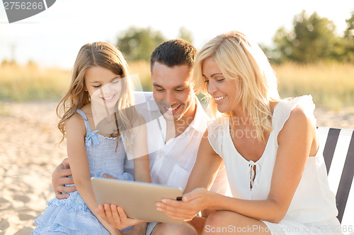 Image of smiling family at beach with tablet pc computer