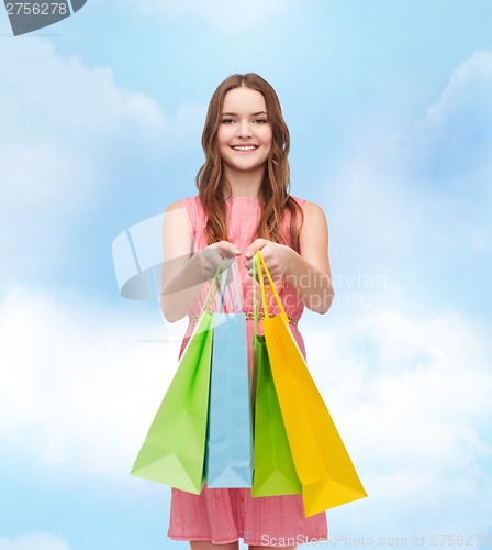 Image of smiling woman in dress with many shopping bags