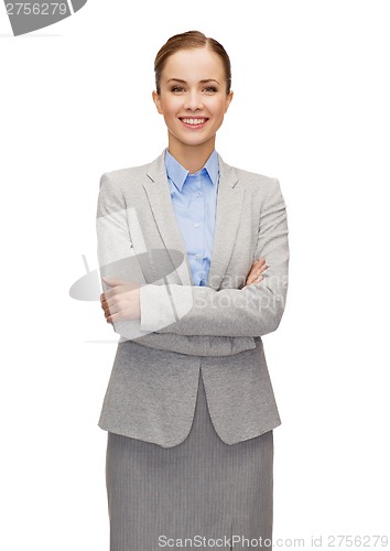 Image of young smiling businesswoman with crossed arms