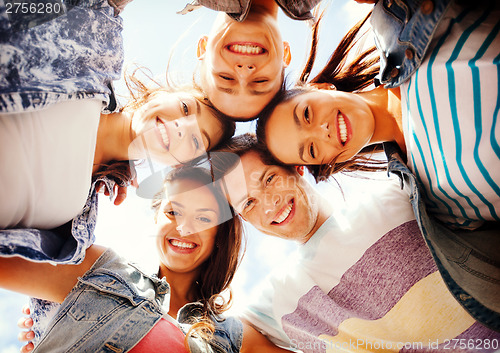 Image of group of teenagers looking down