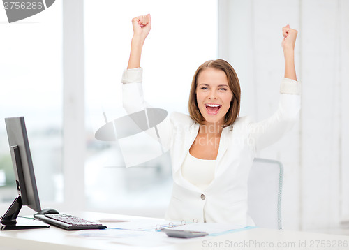 Image of happy businesswoman with computer in office