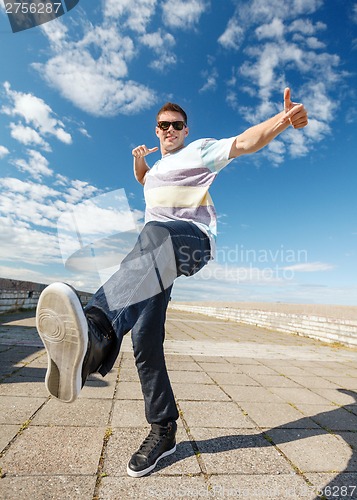 Image of handsome boy making dance move